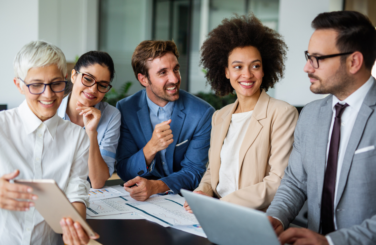 Group of multiethnic successful business people working and communicating at a corporate banking office.